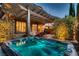 Relaxing backyard setting with a hot tub, covered patio, and lush greenery, designed for outdoor enjoyment at 2435 Granada Bluff Ct, Las Vegas, NV 89135