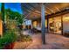 Charming backyard with a covered patio, outdoor seating, and lush landscaping, ideal for outdoor living and entertaining at 2435 Granada Bluff Ct, Las Vegas, NV 89135