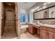 Elegant bathroom featuring a tiled shower, soaking tub, and dual sink vanity at 2435 Granada Bluff Ct, Las Vegas, NV 89135