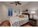 Cozy bedroom featuring a ceiling fan, wood floors, and stylish decor for a relaxing ambiance at 2435 Granada Bluff Ct, Las Vegas, NV 89135
