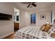 Comfortable bedroom showcasing a stylish bed, hardwood floors, and a glimpse into the bathroom at 2435 Granada Bluff Ct, Las Vegas, NV 89135