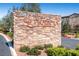 Elegant stone entrance sign adds character to this well-maintained community, surrounded by lush landscaping at 2435 Granada Bluff Ct, Las Vegas, NV 89135