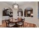 Elegant dining room with wood floors, arched openings, and stylish light fixture at 2435 Granada Bluff Ct, Las Vegas, NV 89135