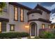 Welcoming entrance featuring an arched doorway and lush landscaping at 2435 Granada Bluff Ct, Las Vegas, NV 89135