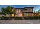 Charming stucco home with a brick walkway, manicured bushes, and inviting curb appeal at 2435 Granada Bluff Ct, Las Vegas, NV 89135