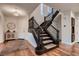 Bright foyer with hardwood floors, grand staircase, and decorative furnishings at 2435 Granada Bluff Ct, Las Vegas, NV 89135