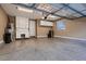 Spacious garage with epoxy floors, storage cabinets, and a workbench, ideal for organization and projects at 2435 Granada Bluff Ct, Las Vegas, NV 89135