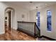 Elegant hallway with hardwood floors and ample natural light streaming through the tall windows at 2435 Granada Bluff Ct, Las Vegas, NV 89135