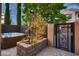 Beautiful backyard featuring a hot tub, decorative stonework, and a gated entrance, perfect for relaxation at 2435 Granada Bluff Ct, Las Vegas, NV 89135