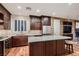 Modern kitchen features granite countertops, stainless steel appliances, and wood flooring at 2435 Granada Bluff Ct, Las Vegas, NV 89135