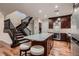 Well-appointed kitchen with granite countertops and stairs leading up to the second floor at 2435 Granada Bluff Ct, Las Vegas, NV 89135