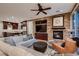 Cozy living room with a fireplace, built-in shelving, and an open layout to the kitchen at 2435 Granada Bluff Ct, Las Vegas, NV 89135