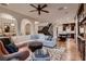 Inviting living room featuring hardwood floors and an open floor plan to kitchen and staircase at 2435 Granada Bluff Ct, Las Vegas, NV 89135
