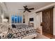 Charming bedroom with a patterned bedspread, modern sliding barn door, and wooden floors at 2435 Granada Bluff Ct, Las Vegas, NV 89135