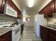Well-lit kitchen featuring white appliances, dark cabinets, and modern countertops at 2606 S Durango Dr # 263, Las Vegas, NV 89117