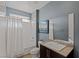 Well lit bathroom featuring tile floors, granite countertop, and shower over tub at 2672 Mystere Ct, Las Vegas, NV 89117