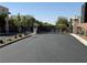 Community entrance with gate surrounded by desert landscaping, and smooth road at 2672 Mystere Ct, Las Vegas, NV 89117