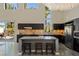 Contemporary kitchen with large island, dark cabinetry, and access to the outdoor patio at 2672 Mystere Ct, Las Vegas, NV 89117