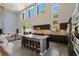 Open concept kitchen with stainless steel appliances, island seating, and backyard views at 2672 Mystere Ct, Las Vegas, NV 89117