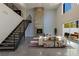 Spacious living room with fireplace, soaring ceilings, and open staircase to the second floor at 2672 Mystere Ct, Las Vegas, NV 89117