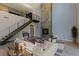 Bright living room with stone fireplace, steel staircase and railings, and modern furnishings at 2672 Mystere Ct, Las Vegas, NV 89117