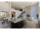 Wide angle shows open living space with kitchen, dining, fireplace and steel staircase at 2672 Mystere Ct, Las Vegas, NV 89117