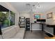 Cozy office featuring a large window, modern desk setup, and comfortable seating area at 2672 Mystere Ct, Las Vegas, NV 89117