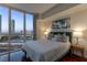 Bedroom features large windows with city views and stylish decor and hardwood floors at 2777 Paradise Rd # 1105, Las Vegas, NV 89109