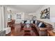 Inviting living room with hardwood floors, a brown leather couch, dining area, and abundant natural light at 2777 Paradise Rd # 1105, Las Vegas, NV 89109