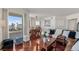 Cozy living room with hardwood floors, dining area, comfortable brown leather couch, and city views from large windows at 2777 Paradise Rd # 1105, Las Vegas, NV 89109