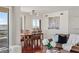 Open concept living and dining room with hardwood floors, brown leather sofa, and city views at 2777 Paradise Rd # 1105, Las Vegas, NV 89109