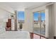 Bright main bedroom featuring hardwood floors, city views, and a sliding glass door to balcony at 2777 Paradise Rd # 1105, Las Vegas, NV 89109