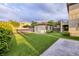 Backyard view featuring green lawn and a shed with a tile roof at 2900 Valvent Ct, Henderson, NV 89044