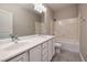 Bright bathroom featuring a double vanity, framed mirror, and shower-tub combo at 2900 Valvent Ct, Henderson, NV 89044