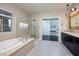 Luxurious bathroom features a soaking tub, glass shower, and double vanity sink at 2900 Valvent Ct, Henderson, NV 89044
