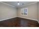 This empty bedroom features hardwood floors, plantation shutters, crown molding, and a ceiling fan at 2900 Valvent Ct, Henderson, NV 89044