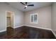 Empty bedroom featuring dark hardwood floors, a ceiling fan, and a walk-in closet at 2900 Valvent Ct, Henderson, NV 89044