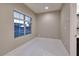 Bedroom featuring neutral colors, tile floors, and a large window at 2900 Valvent Ct, Henderson, NV 89044