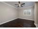 Empty bedroom featuring hardwood floors, crown molding, a modern ceiling fan, and plantation shutters at 2900 Valvent Ct, Henderson, NV 89044