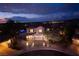 Elegant two-story home at dusk with a three-car garage and beautifully landscaped front yard at 2900 Valvent Ct, Henderson, NV 89044