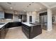 Well-appointed kitchen features stylish pendant lights, stainless steel appliances, and center island at 2900 Valvent Ct, Henderson, NV 89044