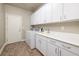 Functional laundry room with white cabinets, sink, counter space, and washer/dryer hookups at 2900 Valvent Ct, Henderson, NV 89044