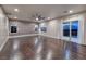 Expansive living room with hardwood floors, windows, and a sliding glass door to balcony at 2900 Valvent Ct, Henderson, NV 89044