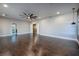 Large, inviting living room with hardwood floors, modern fan, and multiple entry points at 2900 Valvent Ct, Henderson, NV 89044