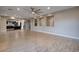 Spacious living room with wood floors and modern ceiling fan that opens to the kitchen at 2900 Valvent Ct, Henderson, NV 89044