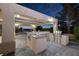 Covered outdoor kitchen with stainless steel appliances, sink, and grill, perfect for entertaining guests at 2900 Valvent Ct, Henderson, NV 89044