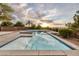 Inviting pool with sparkling blue water surrounded by lush landscaping, reflecting the sky at 2900 Valvent Ct, Henderson, NV 89044