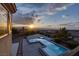 Stunning view of a modern pool and spa area with mountain views at sunset at 2900 Valvent Ct, Henderson, NV 89044