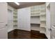This walk-in closet features custom shelving and drawers, providing ample and organized storage space with hardwood floors at 2900 Valvent Ct, Henderson, NV 89044