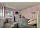 Comfortable bedroom featuring a cozy bed with gray blanket, desk and bright natural light at 301 E Van Wagenen St, Henderson, NV 89015